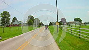 Amish Horse and Buggy Trotting along Residential Road