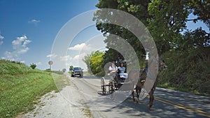 An Amish Horse and Open Buggy With an Amish Couple