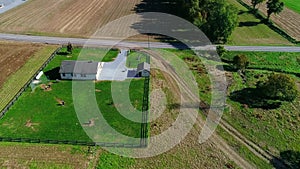 Amish one room school house with Amish children playing baseball as seen by a drone