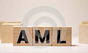 AML anti money laundering acronym on wooden blocks. Government policy and word economy concept