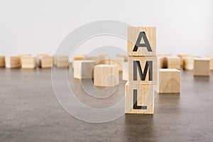 aml text as a symbol on cube wooden blocks. many wooden blocks in the background.