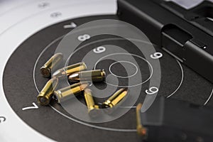 Ammunition and gun on paper target for shooting practice