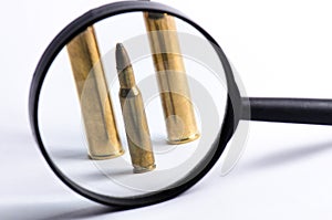 Ammunition on a white background. View through a magnifier. . Close up. Weapons.