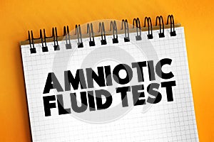 Amniotic Fluid Test is a medical procedure used primarily in the prenatal diagnosis of genetic conditions, text on notepad