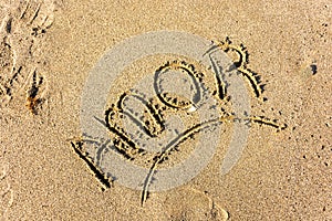Amor love word writen in the sea sand photo