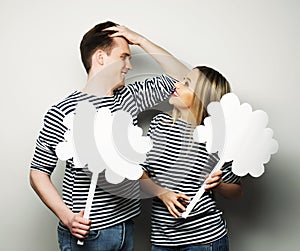 Amorous couple holding blank paper on stick.