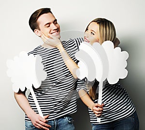 Amorous couple holding blank paper on stick.