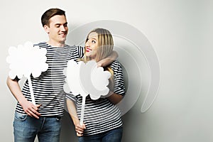 Amorous couple holding blank paper on stick.