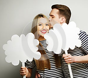 Amorous couple holding blank paper on stick.