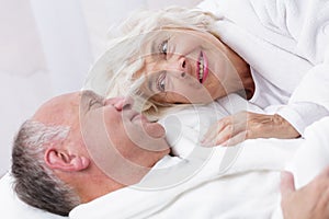 Amorous senior couple in bed