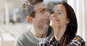Amorous young man kissing his girlfriend