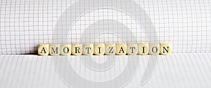 Amortization word on the wooden blocks. amortize concept