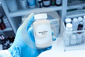 Amoxicillin pill in white bottle, pill stock