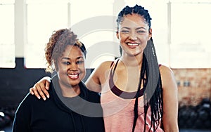 Amped to start exercising. Portrait of two cheerful young women having a conversation while looking into the camera