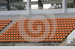 Amphitheater of orange seats in stadium abstract background