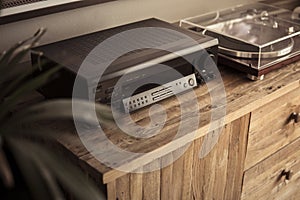 Amplifier and vinyl record player on a wooden sideboard