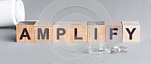 Amplify inscription word on wooden cube blocks on a table. covid symptoms concept photo