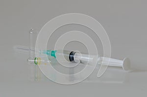 Ampoul, syringe  with needles on white table