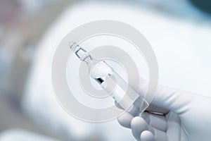 Ampoule with drug in workers hand