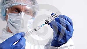 Ampoule with Vaccine COVID-19, Doctor Fills Injection Syringe with Vaccine