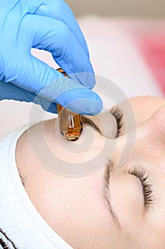 Ampoule with vitamin C for application directly to the face for the mesotherapy procedure with the help of a dermapen. photo