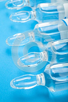 Ampoules of insulin, close-up. Blue background