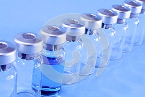 Ampules in a row on blue