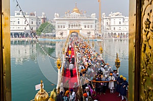 Amritsar, India - November 21, 2011: Sikh pilgrims stand in line at the bridge to get to the Golden Temple. Amritsar, Punjab,