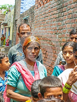 Amroha, Uttar Pradesh, India - 2011- a group of adukt people and children living in the slums