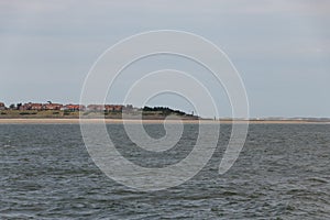 Amrum in Germany from ferry at a partly cloudy day