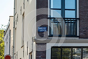 Amstel centrum in Amsterdam. Sign on the wall with a balcony photo