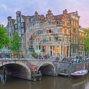 Amstel river, canals and night view of beautiful Amsterdam city. Netherlands