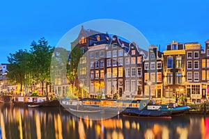 Amstel river, canals and night view of beautiful Amsterdam city. Netherlands