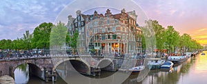 Amstel river, canals and night view of beautiful Amsterdam city. Netherlands