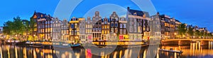 Amstel river, canals and night view of beautiful Amsterdam city. Netherlands