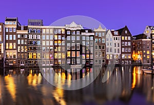 Amsterdam architecture on Damrak canal at night, Netherlands