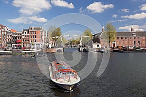 Amsterdam with boats on canal in Holland