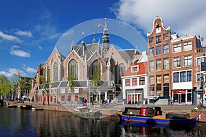 Amsterdam with boats on canal in Holland