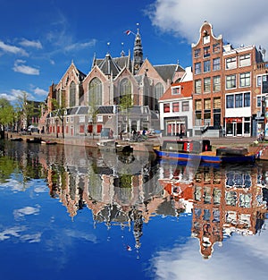 Amsterdam with boats on canal in Holland