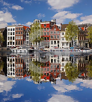 Amsterdam with boats on canal in Holland