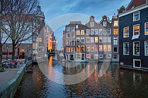 Amsterdam buildings at dusk with water canals and reflections, Netherlands