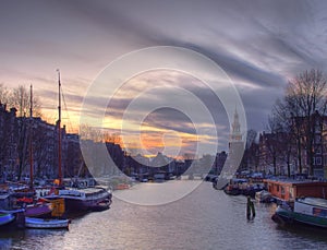 Amsterdam canal Amstel with typical dutch houses and houseboat from the boat in the evening, Holland, Netherlands