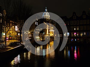 Amsterdam canal Amstel with typical dutch houses and houseboat from the boat in the evening, Holland, Netherlands