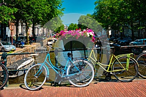 Amsterdam canal with boats and bicycles on a bridge