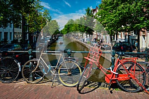 Amsterdam canal with boats and bicycles on a bridge