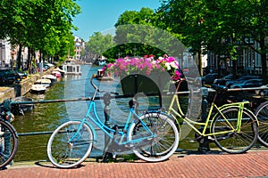 Amsterdam canal with boats and bicycles on a bridge