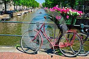 Amsterdam canal with boats and bicycles on a bridge