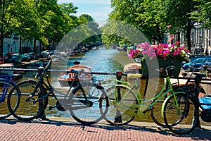 Amsterdam canal with boats and bicycles on a bridge