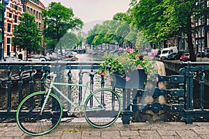 Amsterdam canal with boats and bicycles on a bridge