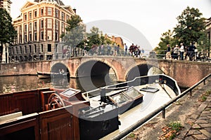 Amsterdam canal and bridge with vintage wooden boat